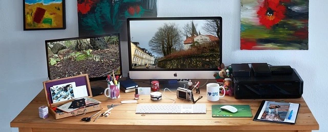 Photography of IMac on Desk with Lot of Photos