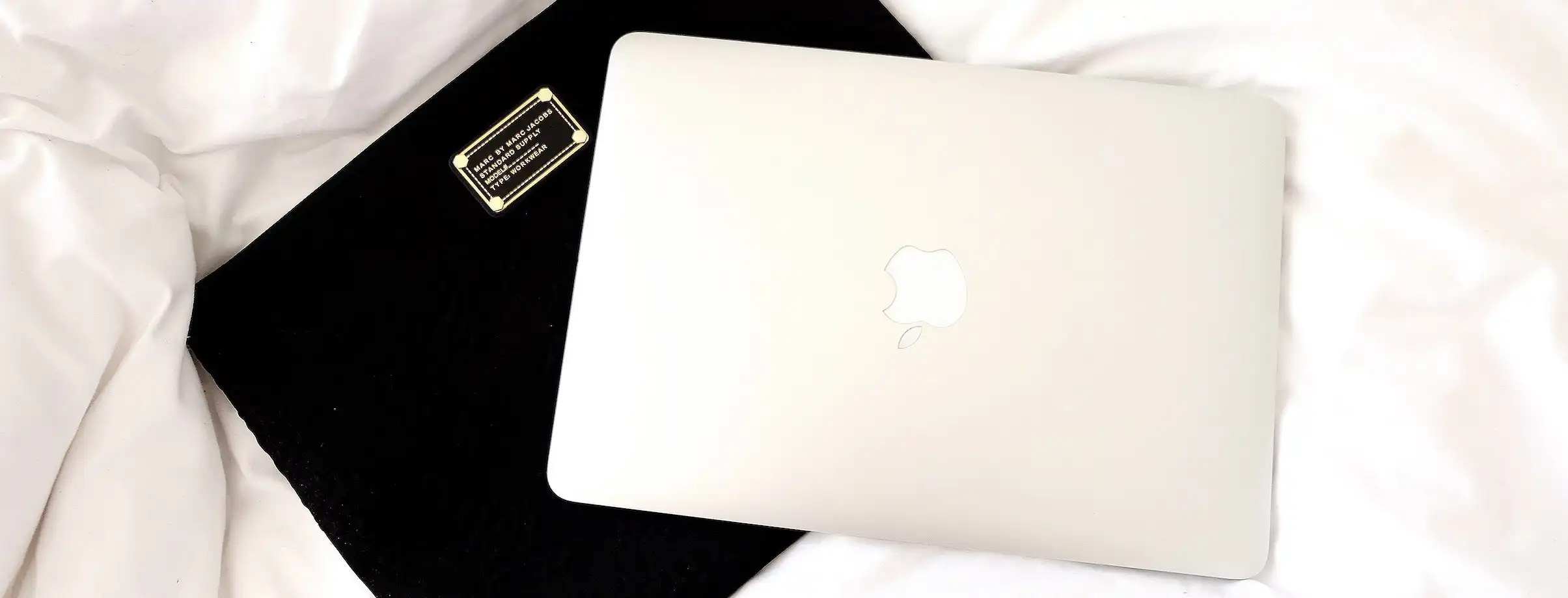 Macbook Air on Top White Blanket