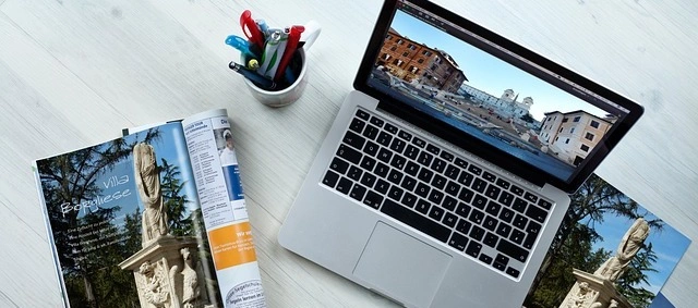 Photography of Macbook Pro with Magazine