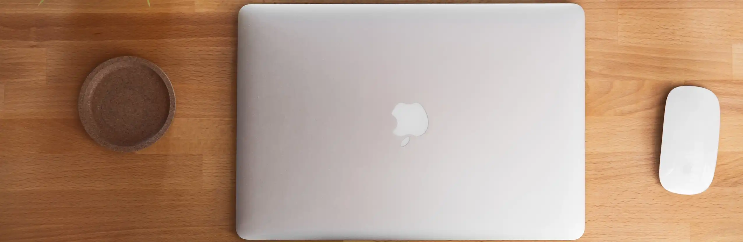 Photograph of Macbook With Magic Mouse and Coaster