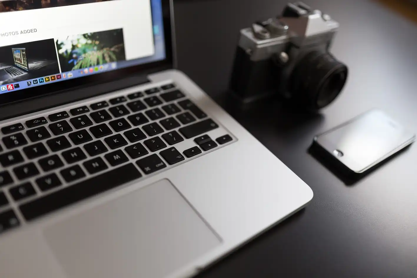 Photograph MacBook with Camera and Smartphone
